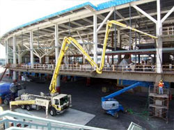 Boom pump feeding an elevated concourse slab on a commercial build