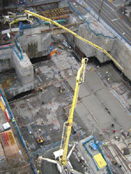 Aerial view of two boom pumps servicing a deep downtown excavation