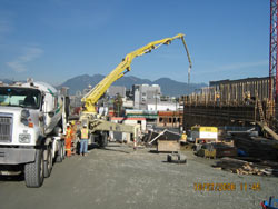 Concrete pump on site with placement crew working the line