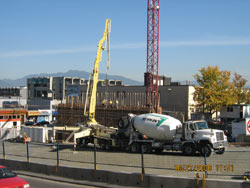 Boom pump and ready-mix truck staged on a cleared commercial site