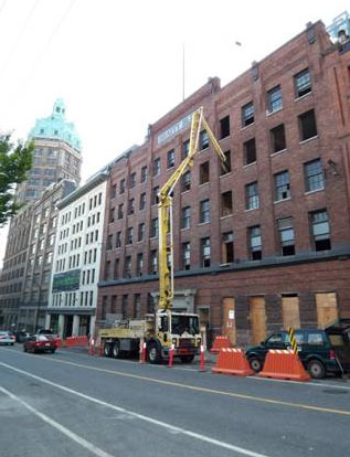 Boom pump working over a heritage brick building in downtown Vancouver