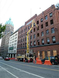 Boom pump working over a heritage brick building in downtown Vancouver