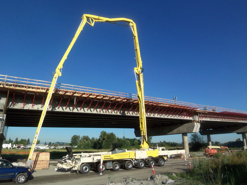 Boom pump placing concrete for a marine pier rebuild on the coast