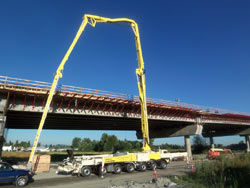 Boom pump placing concrete for a marine pier rebuild on the coast