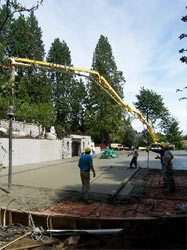Placing and finishing a residential driveway slab through a boom line